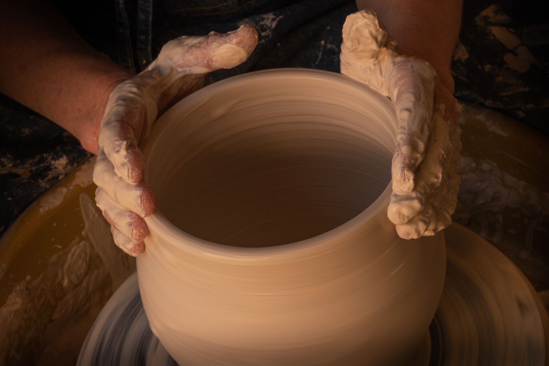 An image of a pottery wheel that someone is working on.